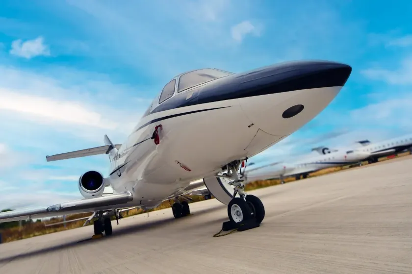 Luxury private jet on tarmac under a blue sky. ► Charter-A Ltd Charter-a ltd private jet
